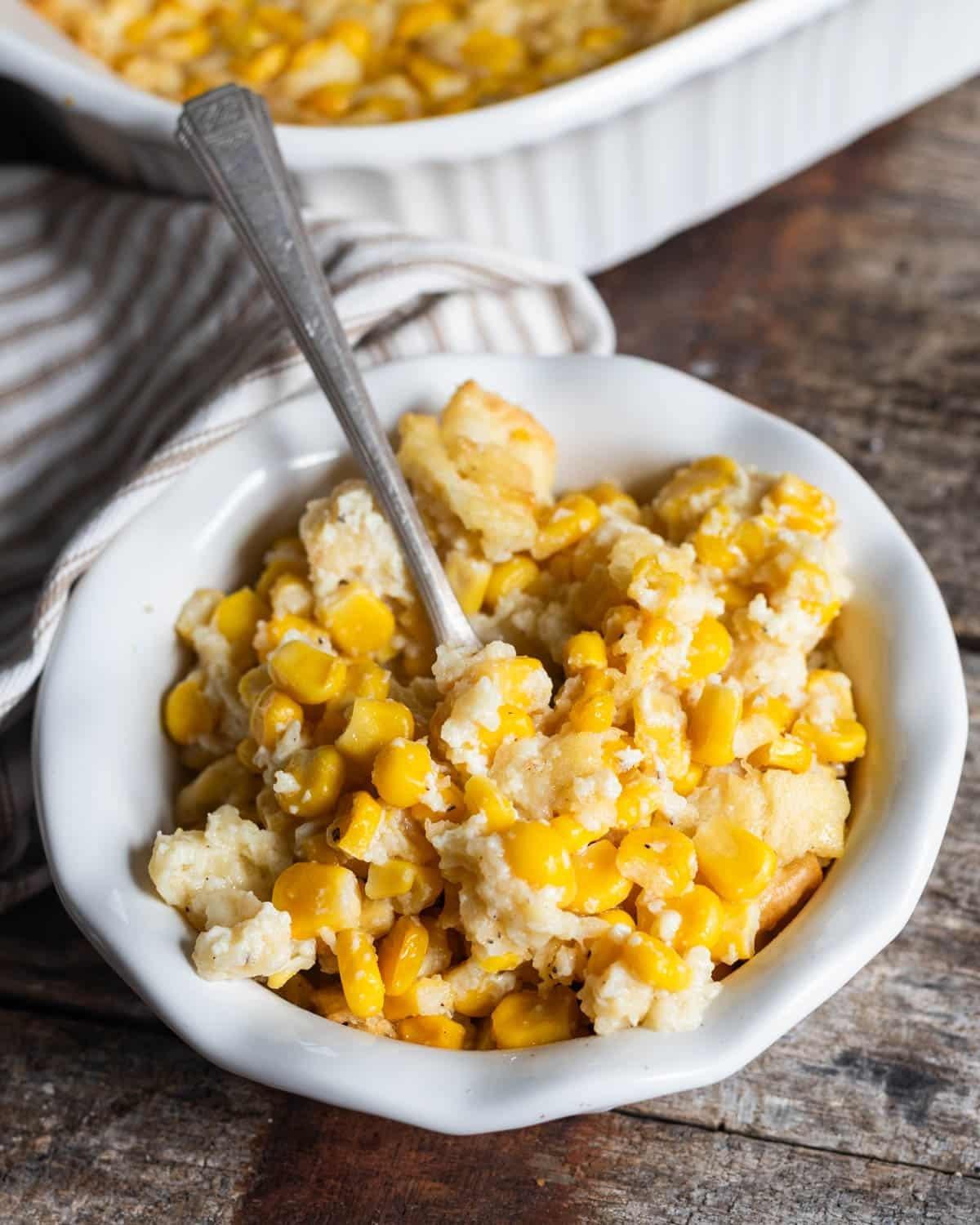 Grandma's hands stirring corn casserole ingredients in a bowl, vintage kitchen