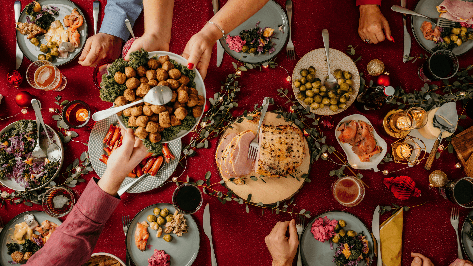 Holiday party scene with people enjoying finger foods and drinks
