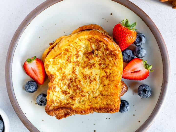 Close-up shot of a slice of brioche toast with visible texture and toppings