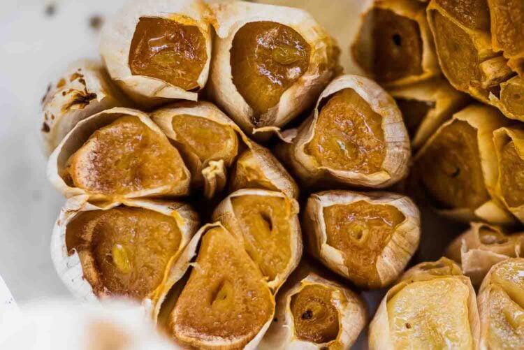 Close-up of a perfectly roasted head of garlic, golden brown