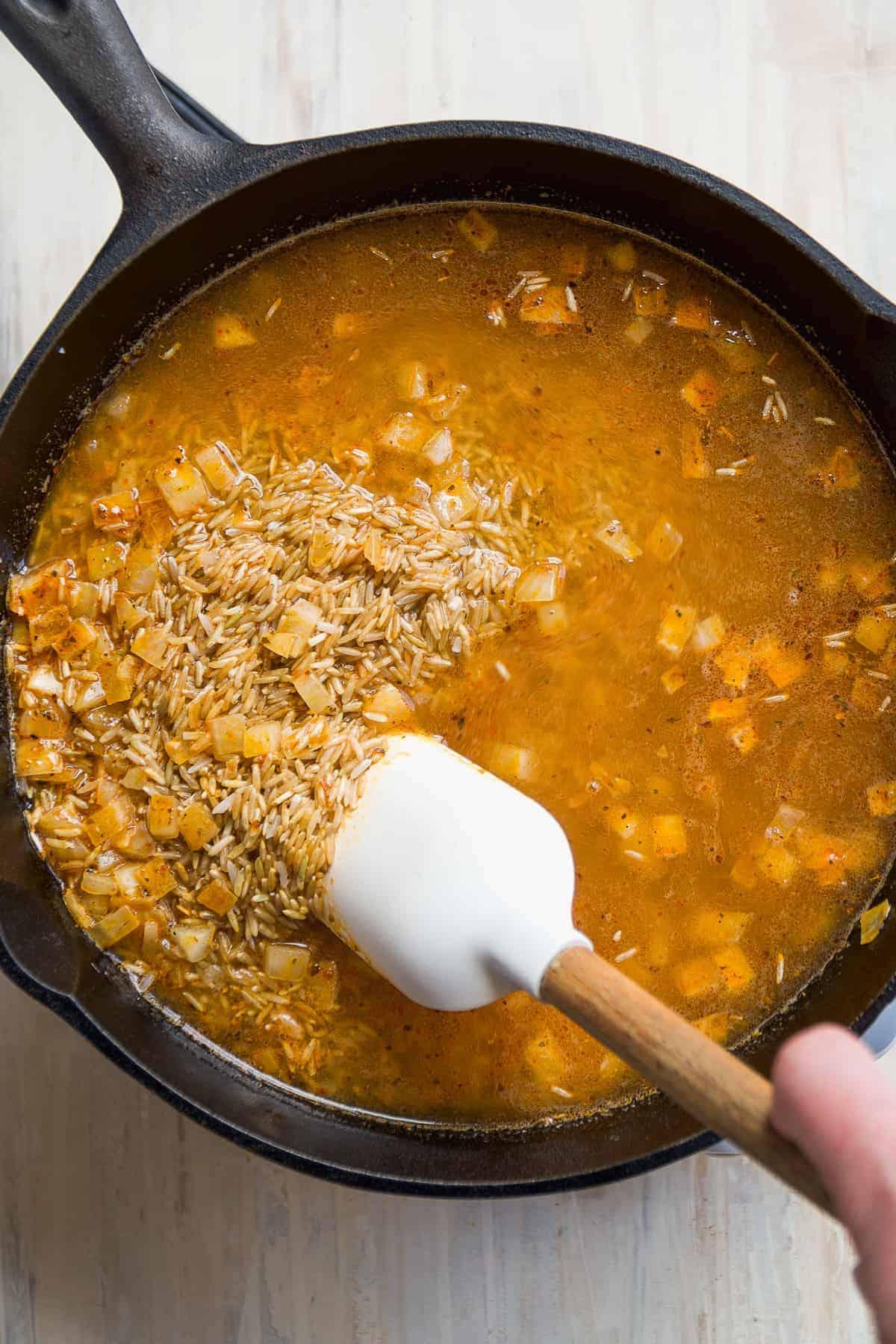 aerial view of a spoonful of spicy cajun shrimp & rice soup