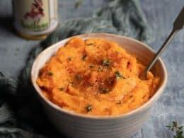 creamy sweet potato mash being spooned into a serving dish
