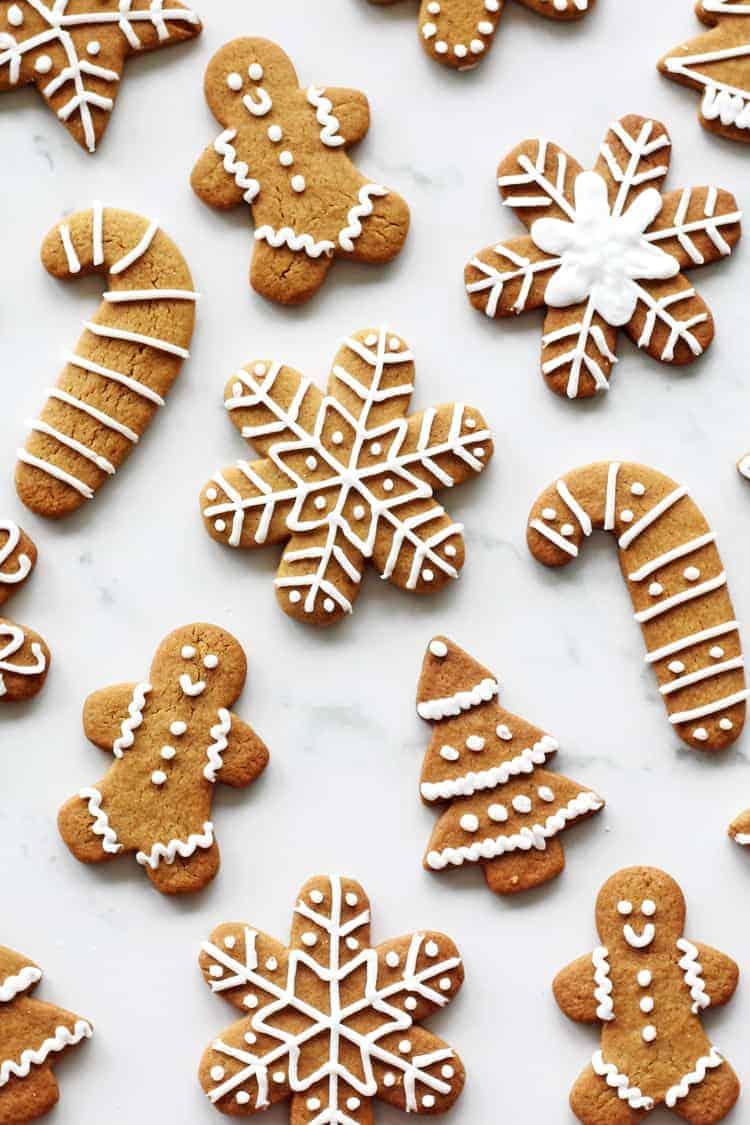 collection of gingerbread cookies with various shapes and intricate icing patterns