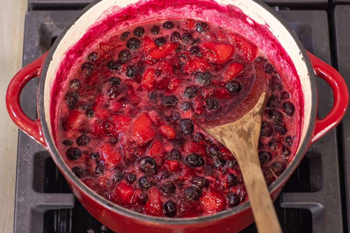 fresh berry compote simmering in a saucepan