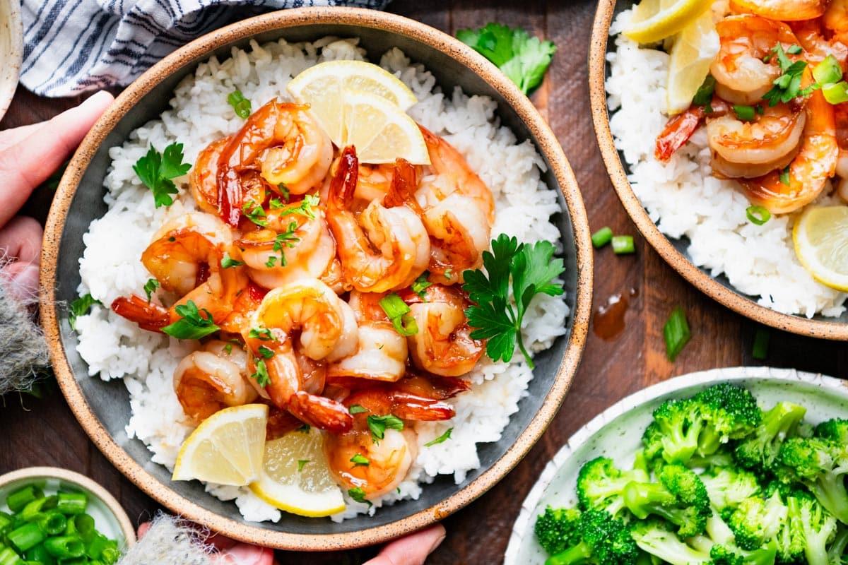 Overhead shot of honey garlic shrimp served with white rice and green onions