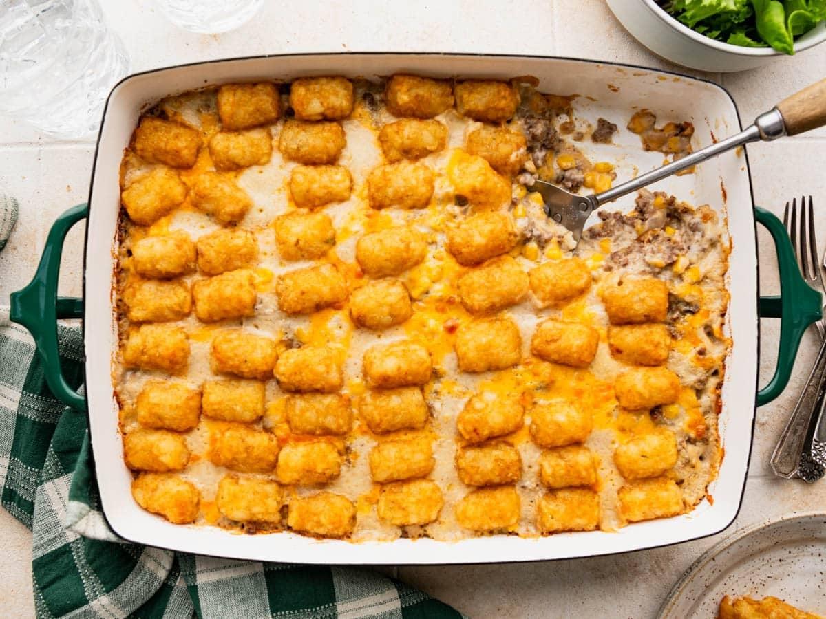 Close-up shot of a golden-brown cheesy topping on a cowboy casserole, bubbling slightly