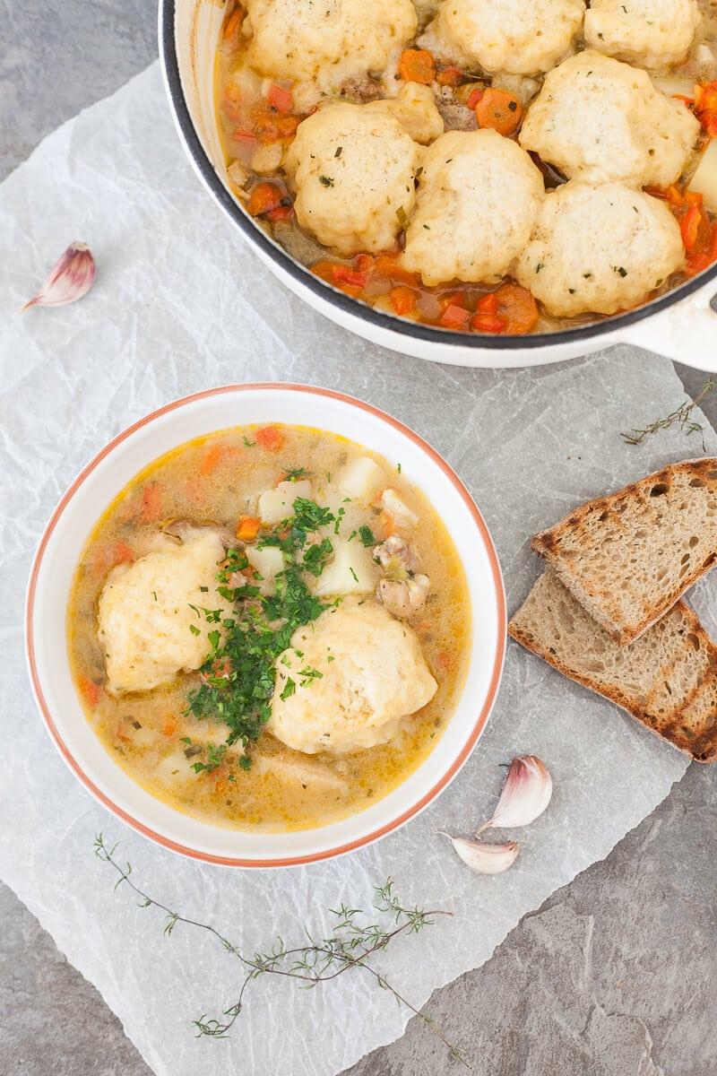 Close-up of fluffy homemade dumplings simmering in chicken stew