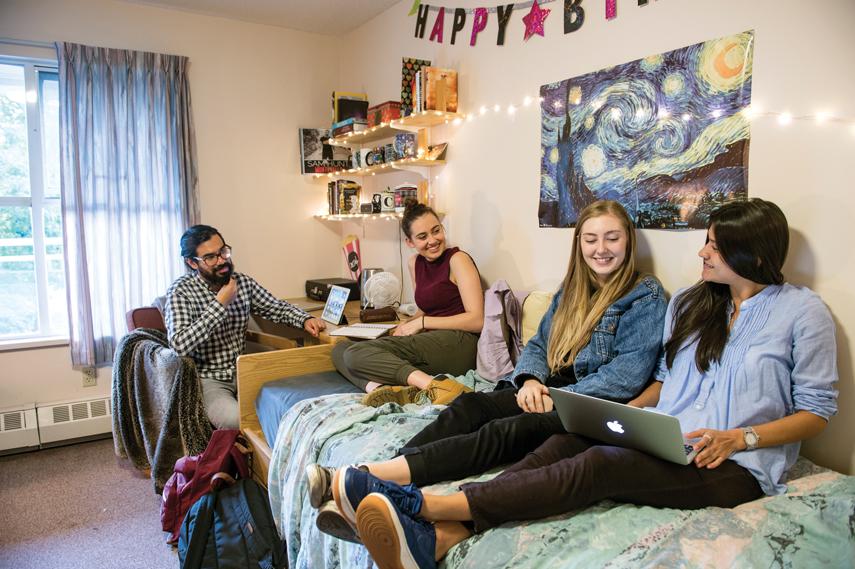 happy college student in a dorm room