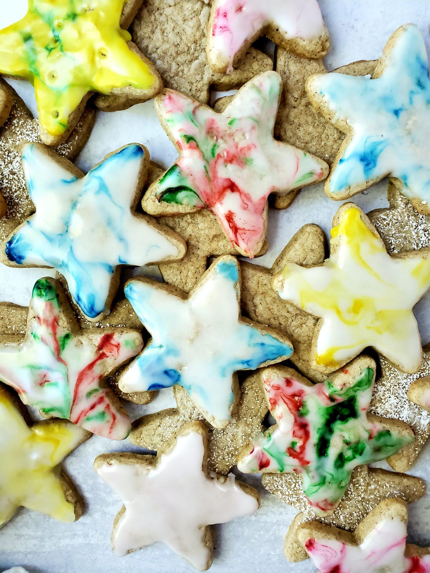 Close-up of a finished star-cut cookie with a shiny, colorful glaze
