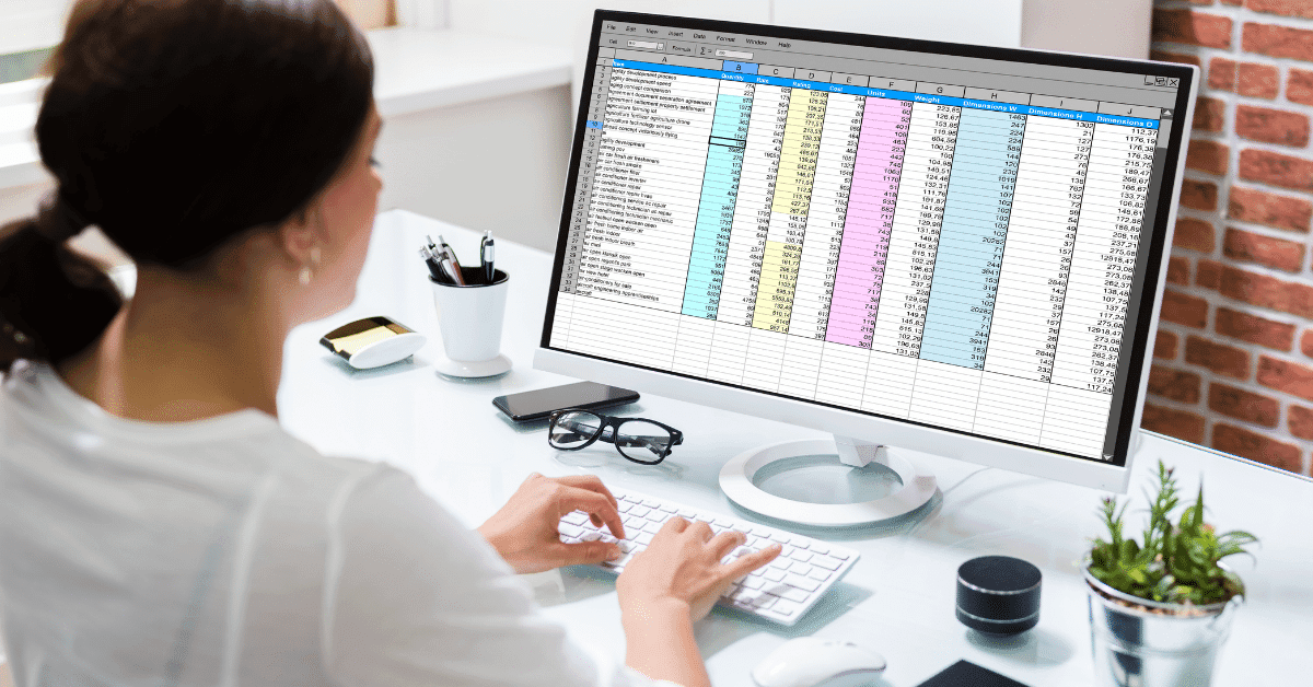 woman auditing content on her computer with a spreadsheet