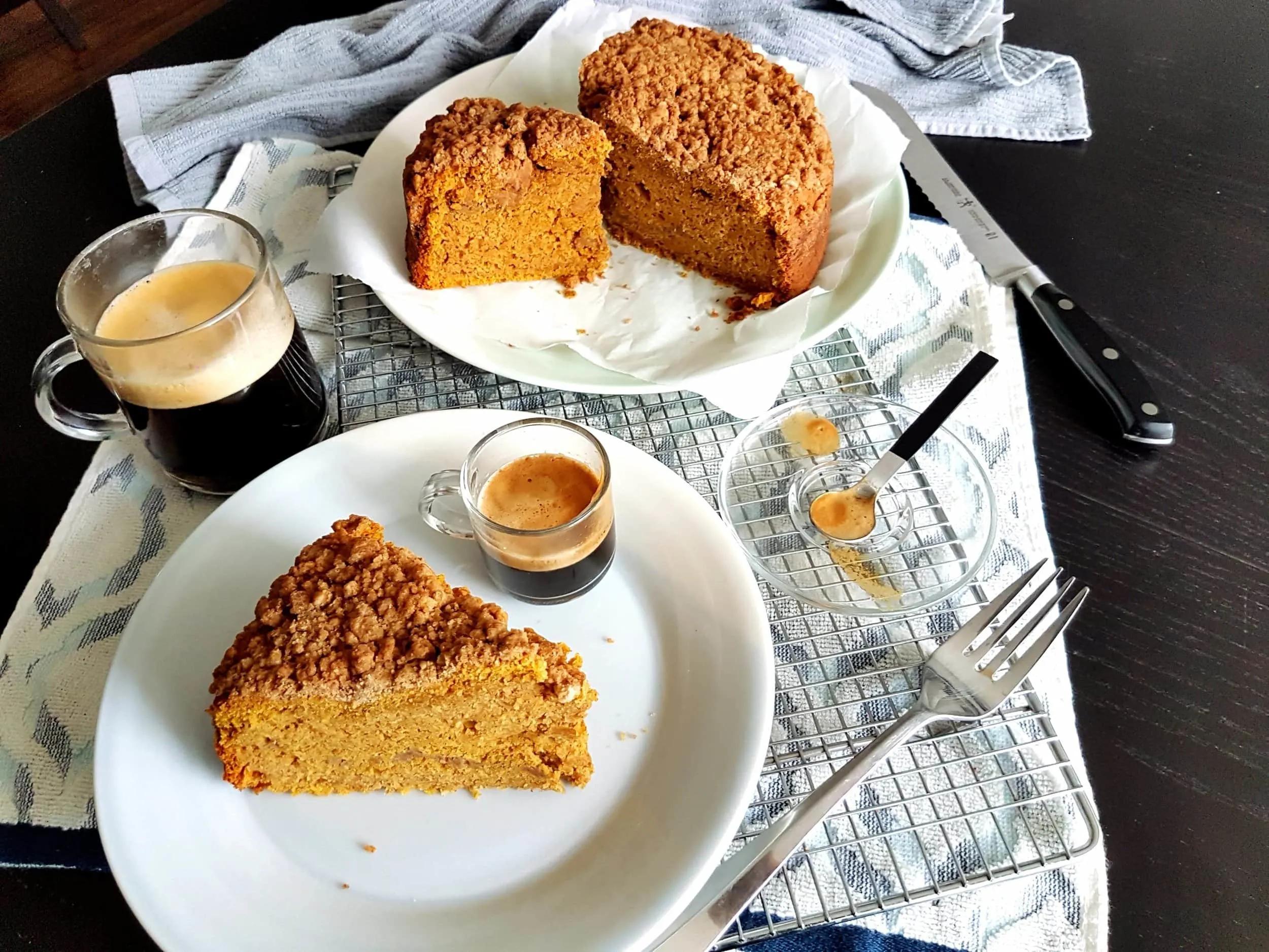 Close-up of pumpkin coffee cake slice with coffee cup