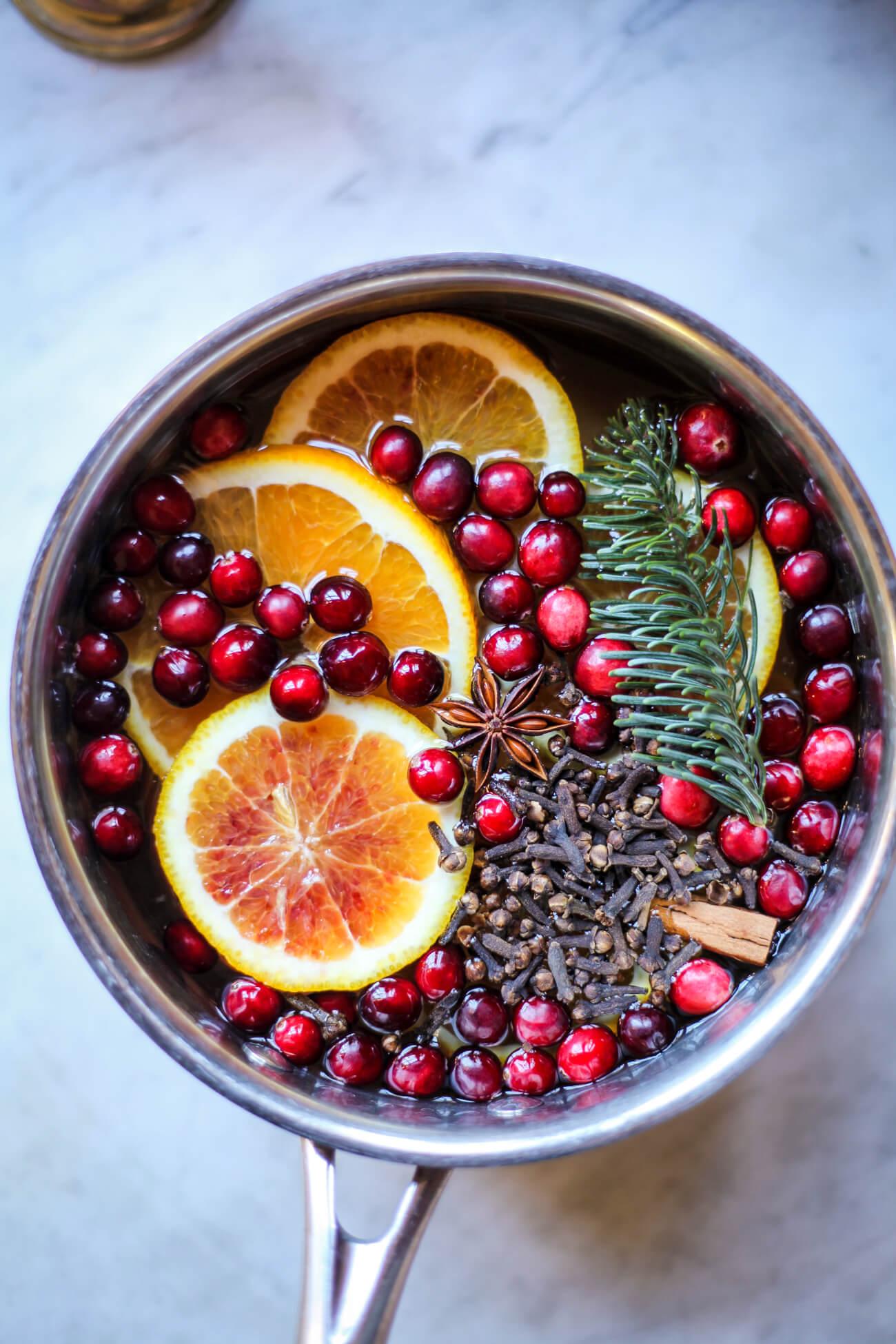 large pot of simmering orange clove punch on a stovetop