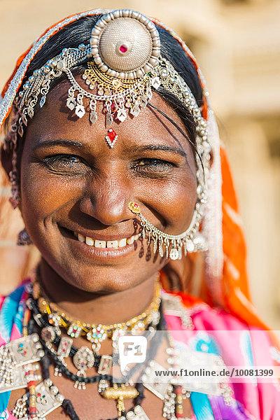 woman smiling wearing colorful jewelry