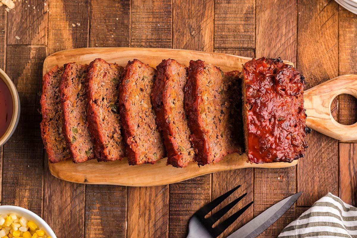 Ingredients for smoky herb meatloaf laid out on a wooden board