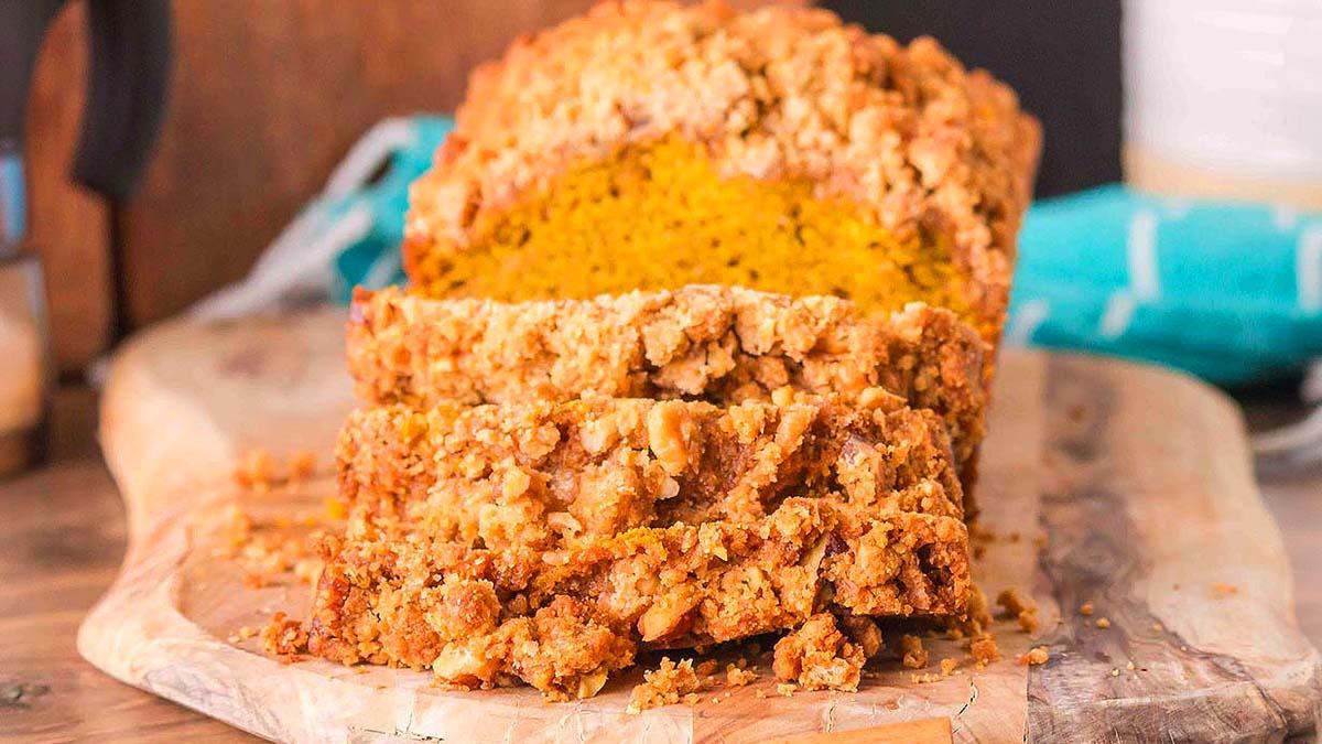 pumpkin streusel bread loaf on a wooden board