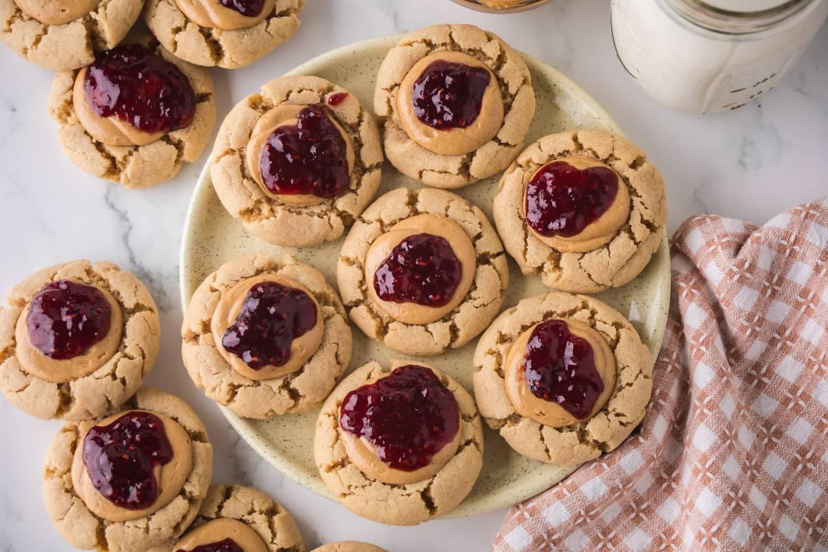 warm peanut butter cookies with jam centers, rustic kitchen setting, cozy feel, sunlight