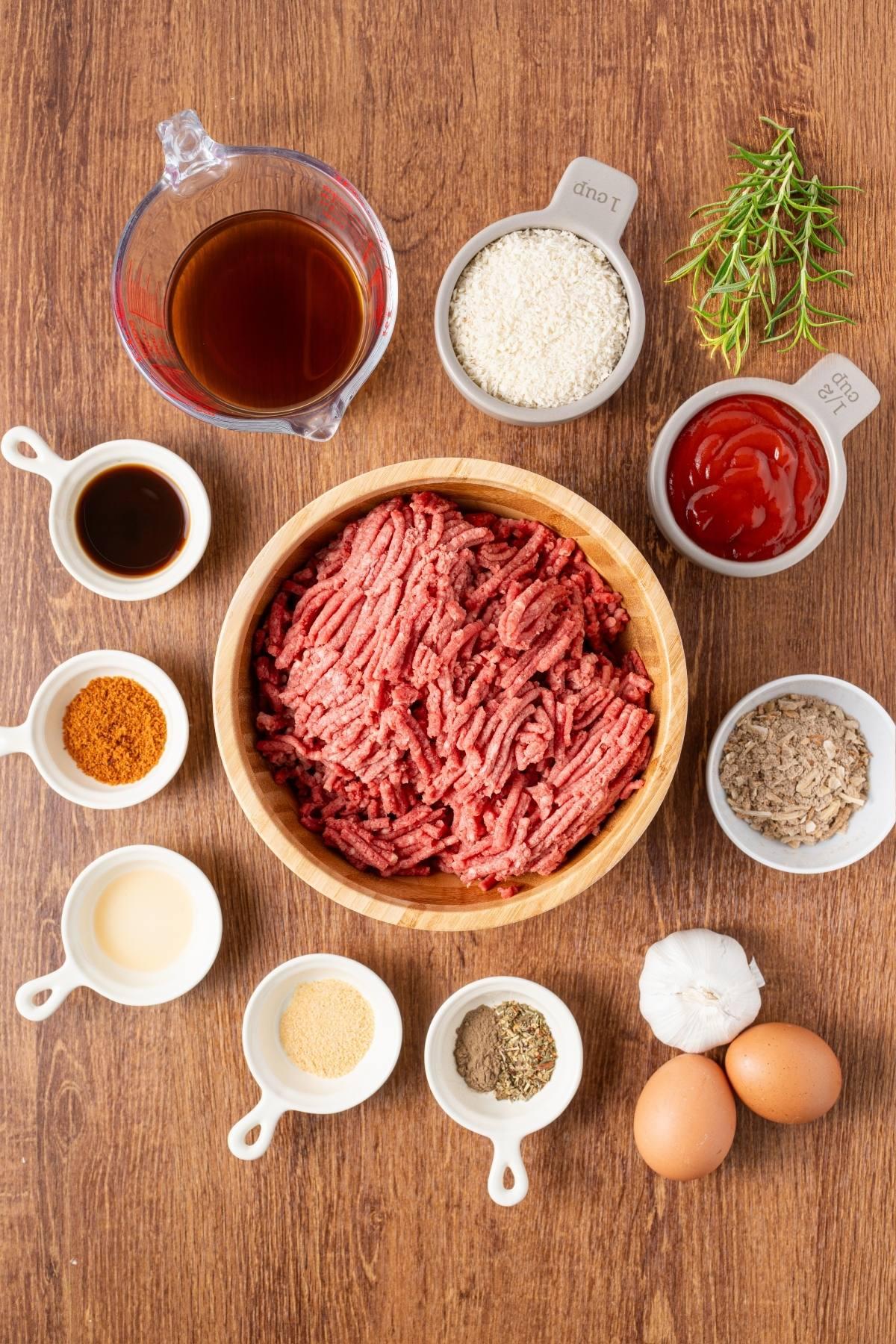 ingredients for meatloaf arranged on a wooden table