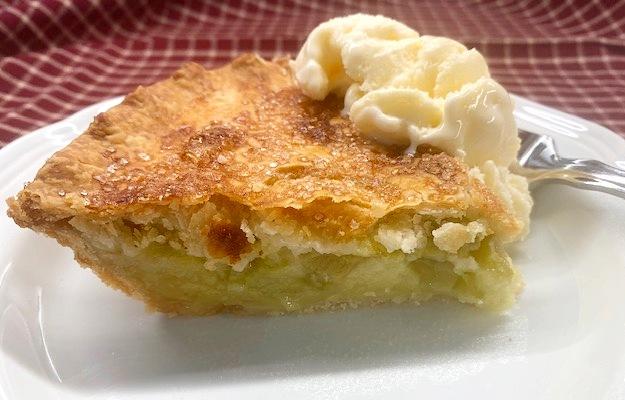 slice of orange blossom rhubarb custard pie on a plate