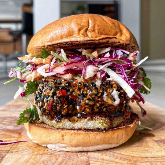Tofu burger on a sesame seed bun with fresh toppings