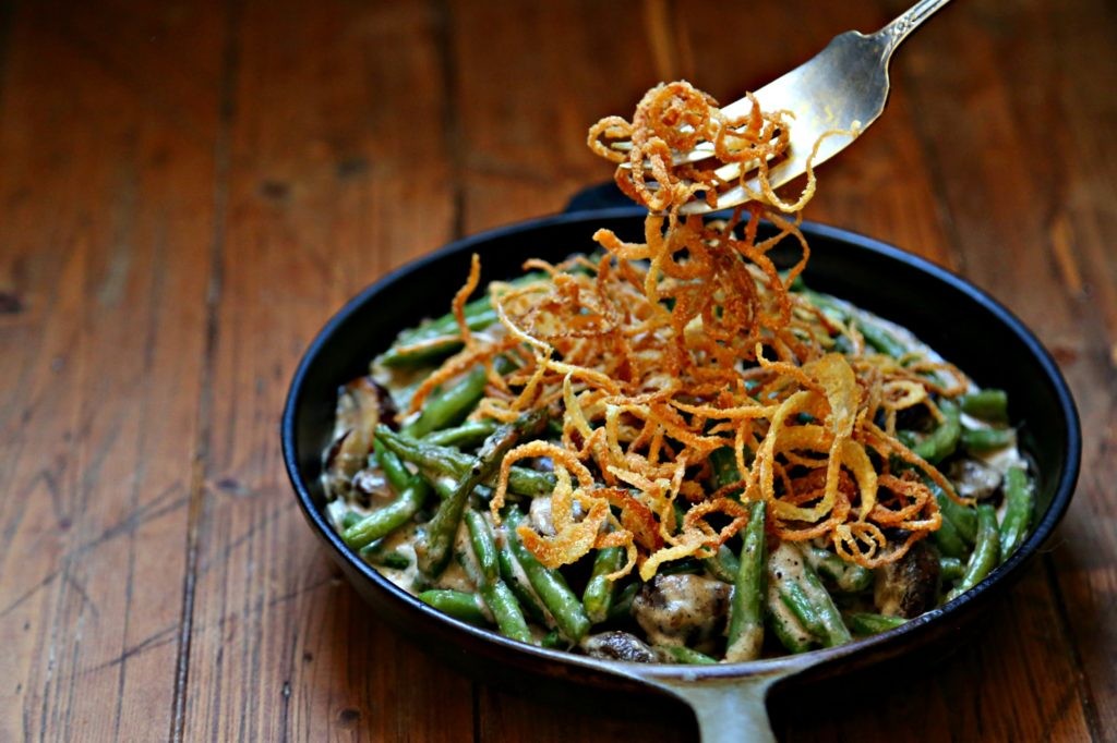 Classic green bean casserole with crispy onions, fresh out of the oven, close up shot