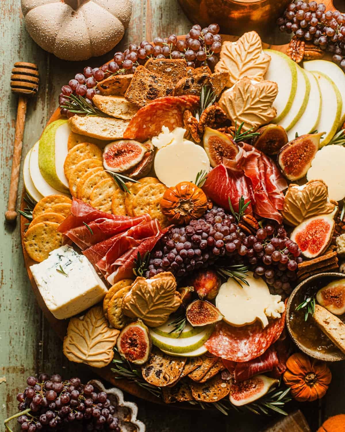 overhead shot of a fall charcuterie board with various cheeses, fruits, and nuts