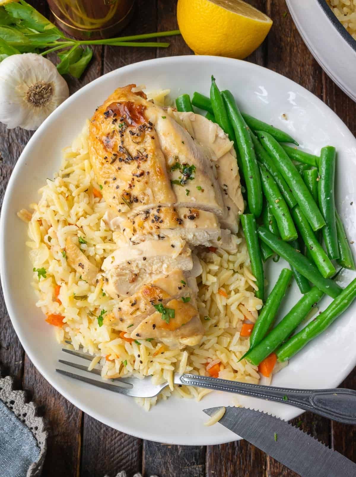 oven-baked lemon herb chicken and rice with fresh parsley garnish