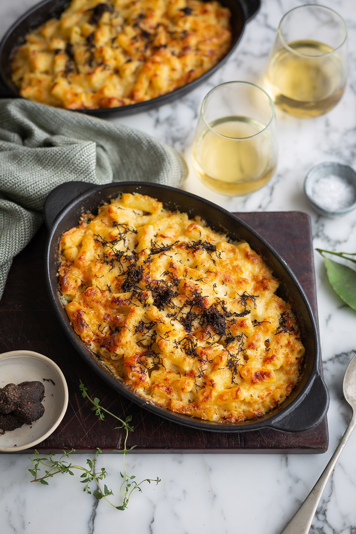 Gourmet truffle mac and cheese with a golden-brown top, served in a rustic skillet