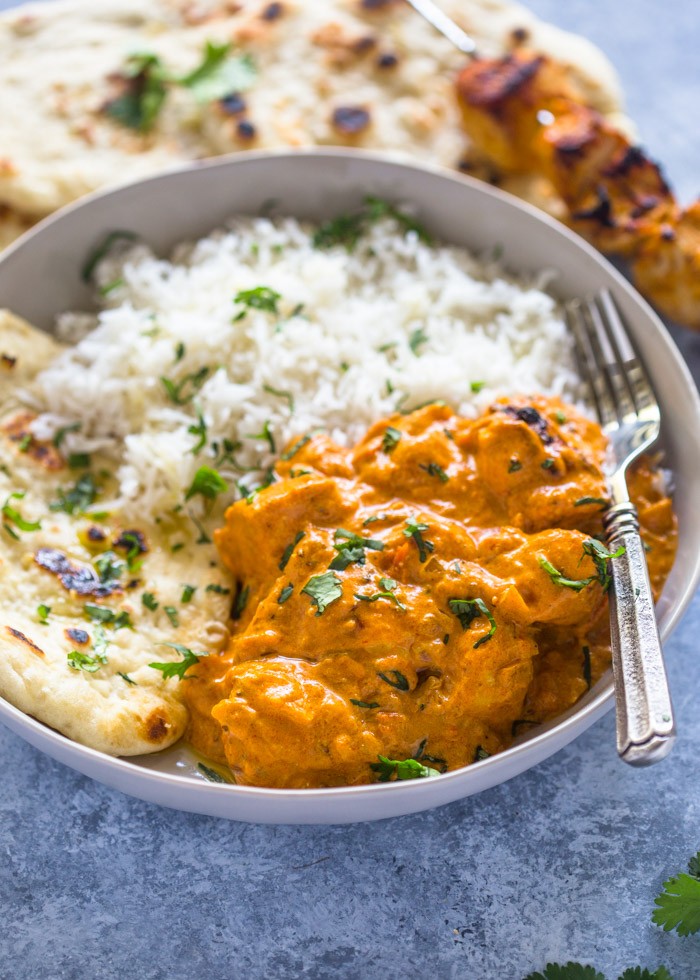 Chicken Tikka Masala served in a bowl with rice and naan