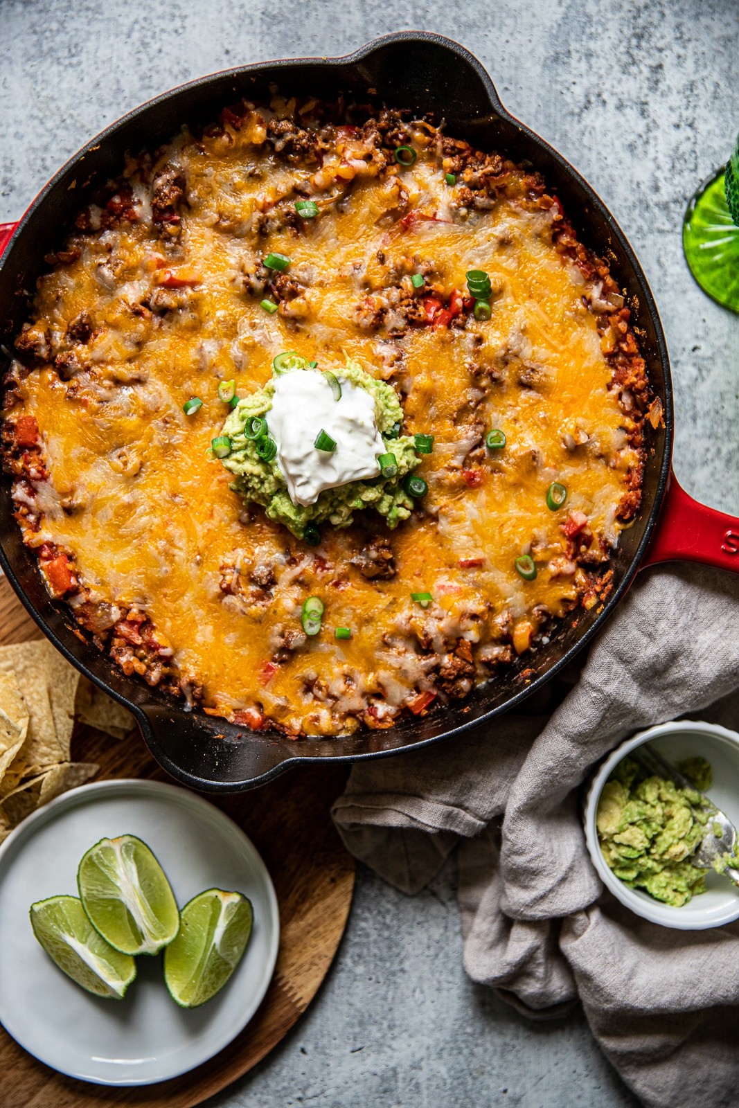vibrant ground beef taco skillet with melted cheese and fresh toppings, aerial view, warm lighting
