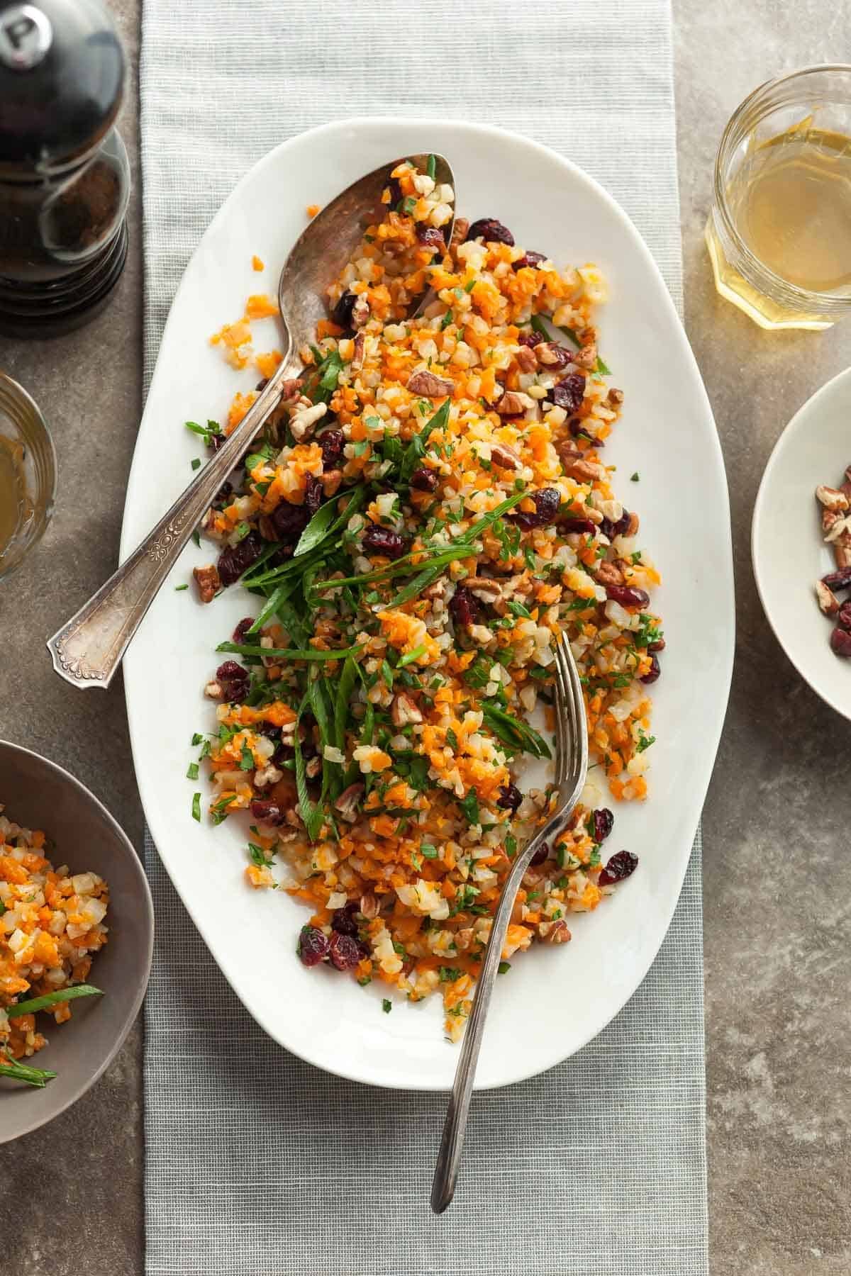 A vibrant bowl of cauliflower rice pilaf with fresh green herbs, in a rustic kitchen setting, natural light