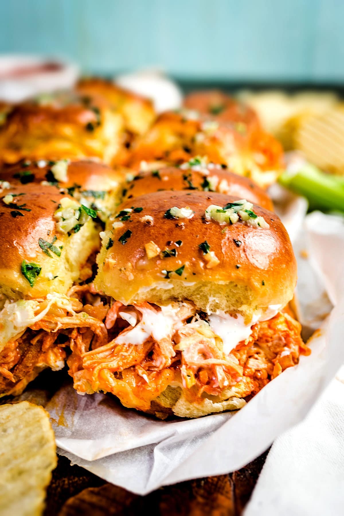 appetizing buffalo chicken sliders piled high with ranch dressing drizzle