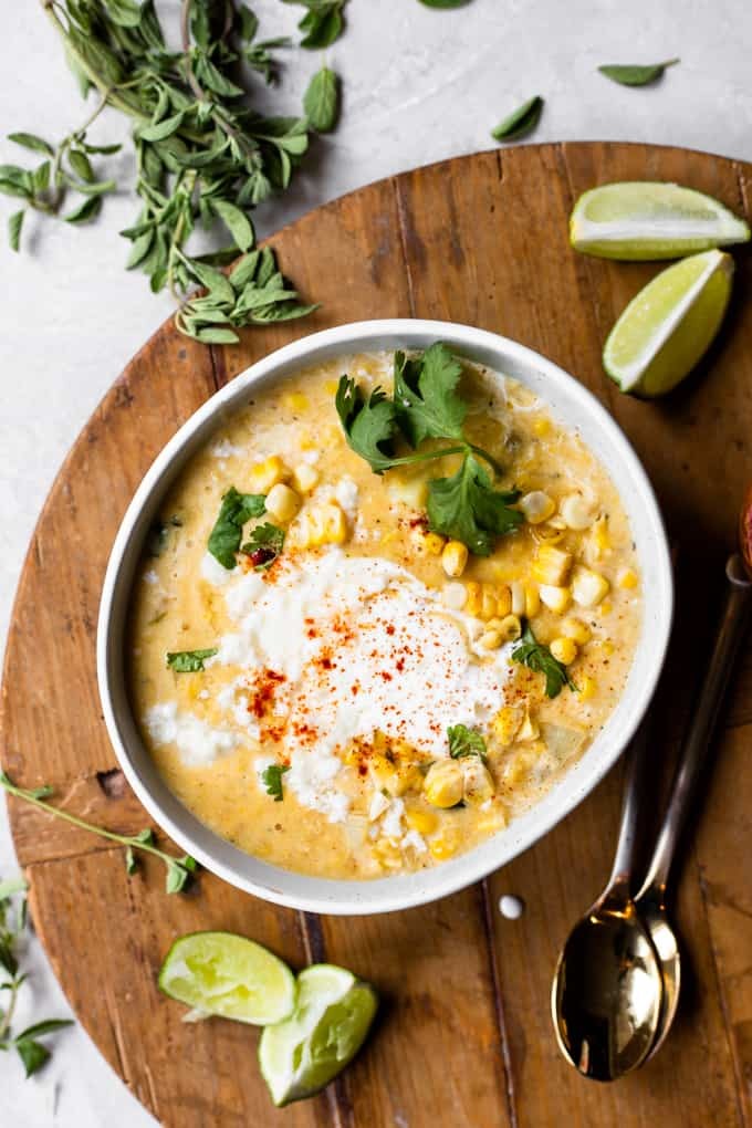 bowl of creamy Mexican street corn soup topped with cilantro and chili powder