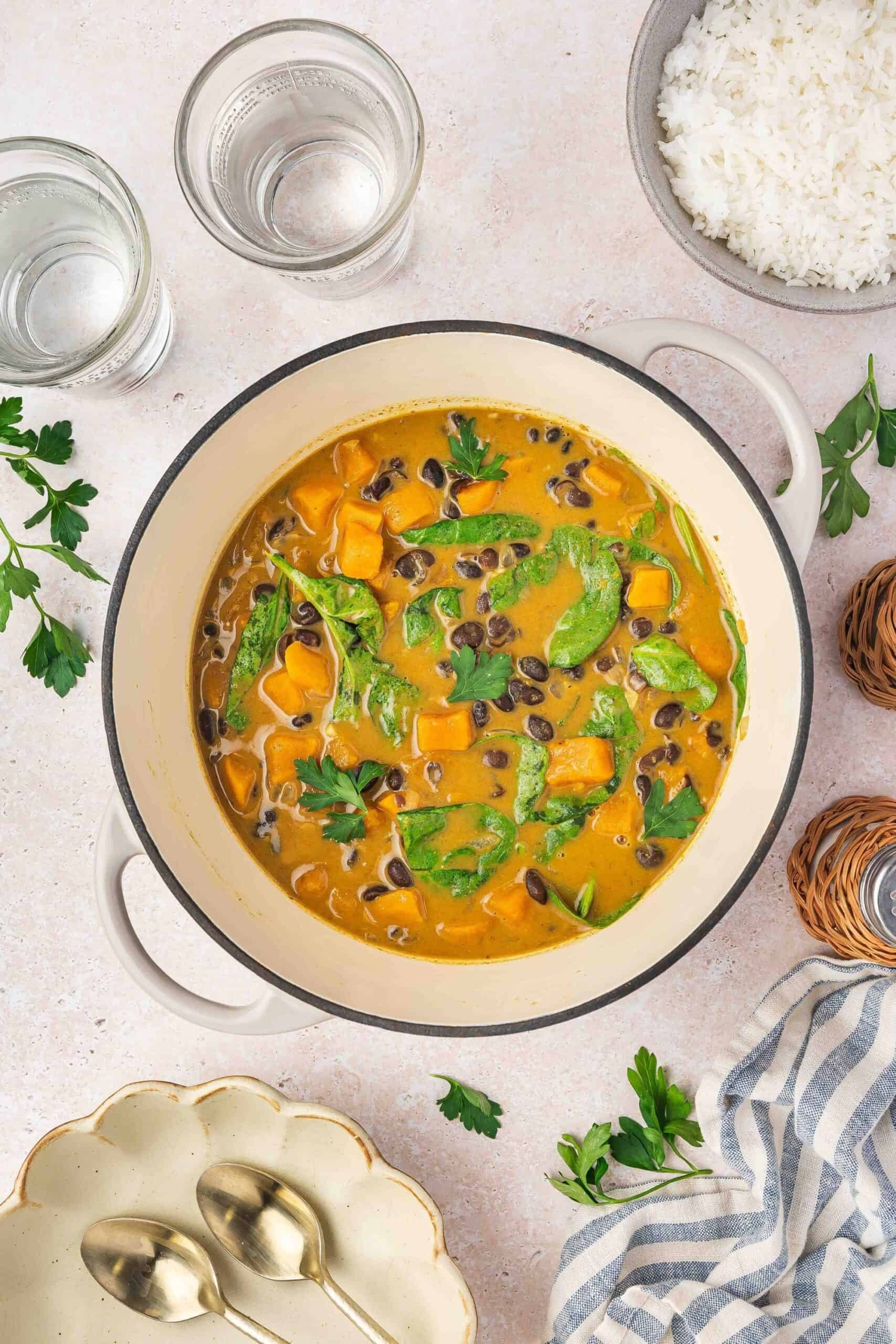 vibrant sweet potato coconut curry simmering in a pot, warm and inviting