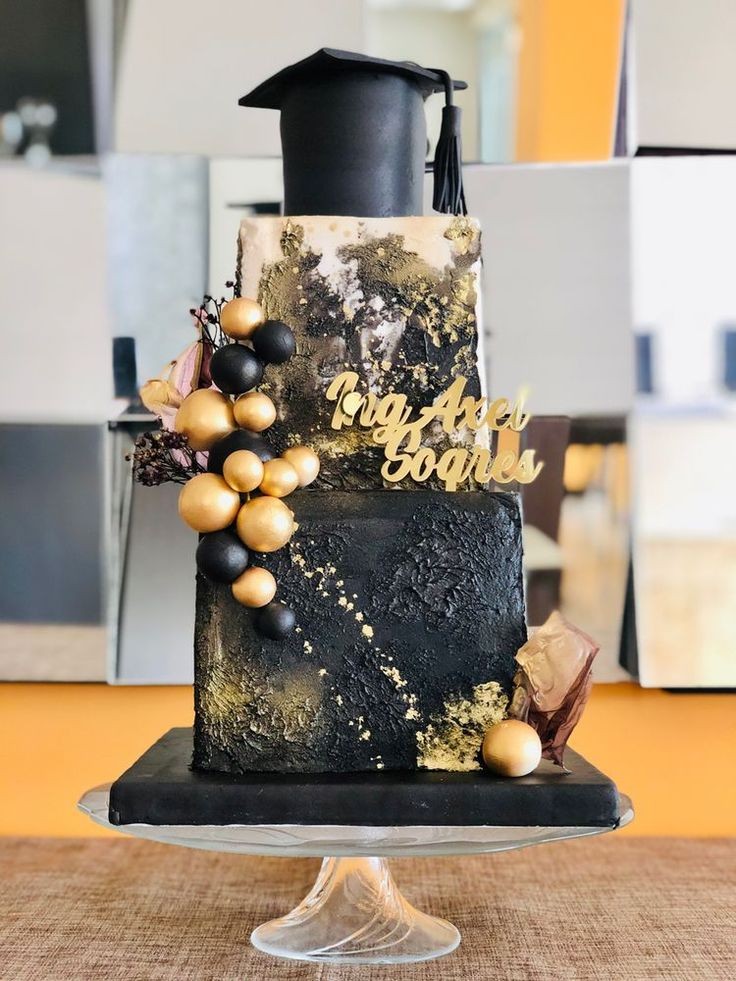 a beautifully decorated graduation gown cake on a table with graduation decorations