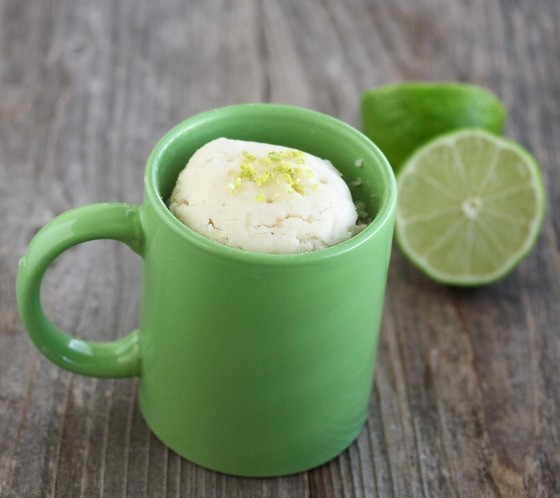 close up shot of a coconut lime mug cake with a spoon
