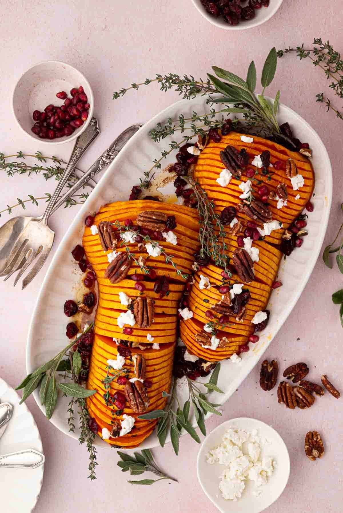 Thanksgiving maple butternut squash gratin with herbs, golden brown, festive table setting