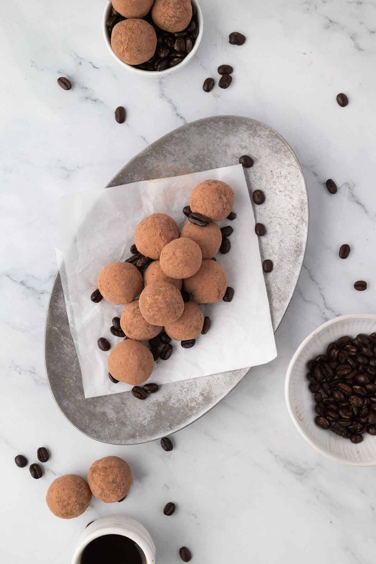 Homemade espresso truffles dusted with cocoa, arranged artfully on a plate