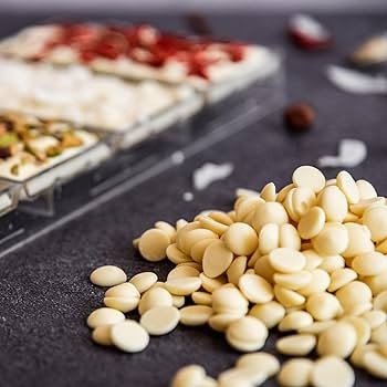 White chocolate drops melting, close up, gourmet