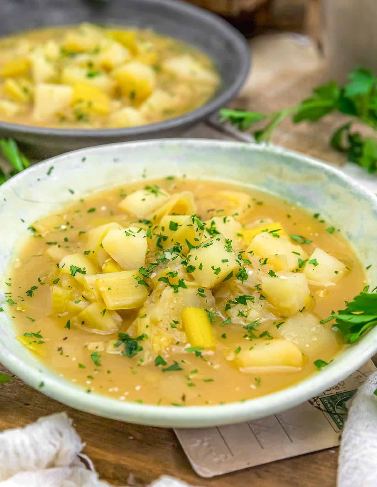 hearty potato leek soup in a rustic bowl with crusty bread, cozy atmosphere, overhead shot