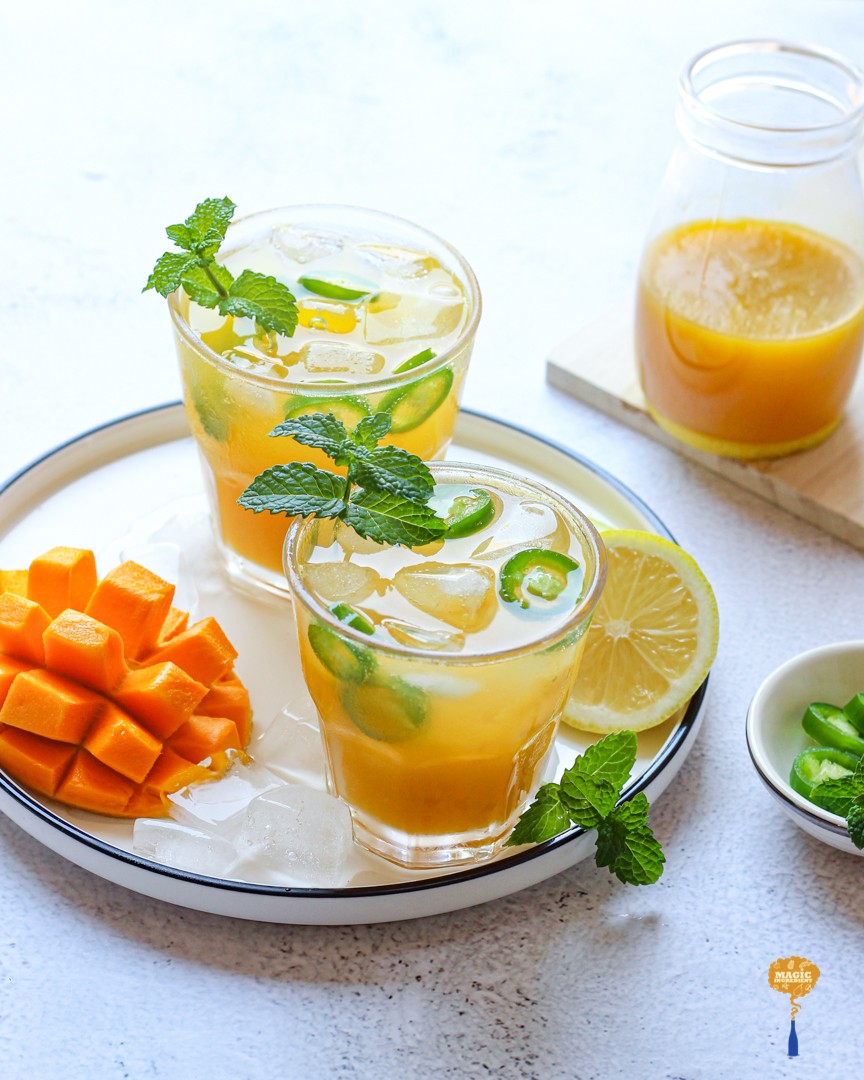 Vibrant mango mint cooler in a festive glass, holiday background