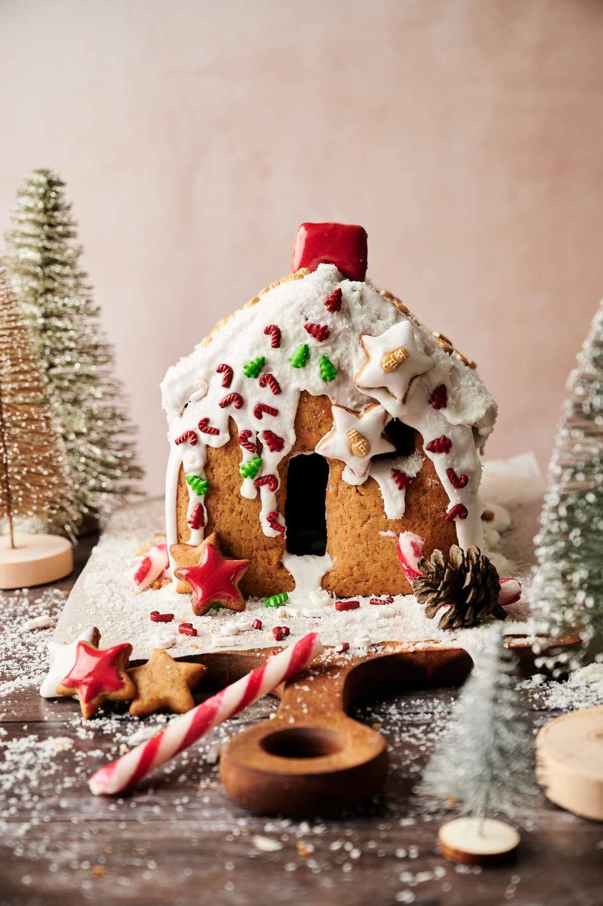 beautifully decorated gingerbread house with soft cookie walls, festive lighting, warm cozy atmosphere