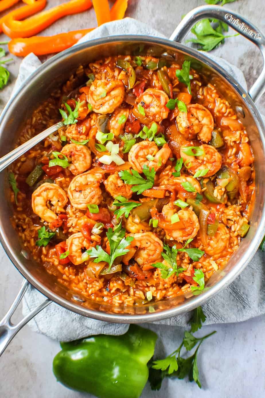 bowl of spicy cajun shrimp and rice soup garnished with parsley