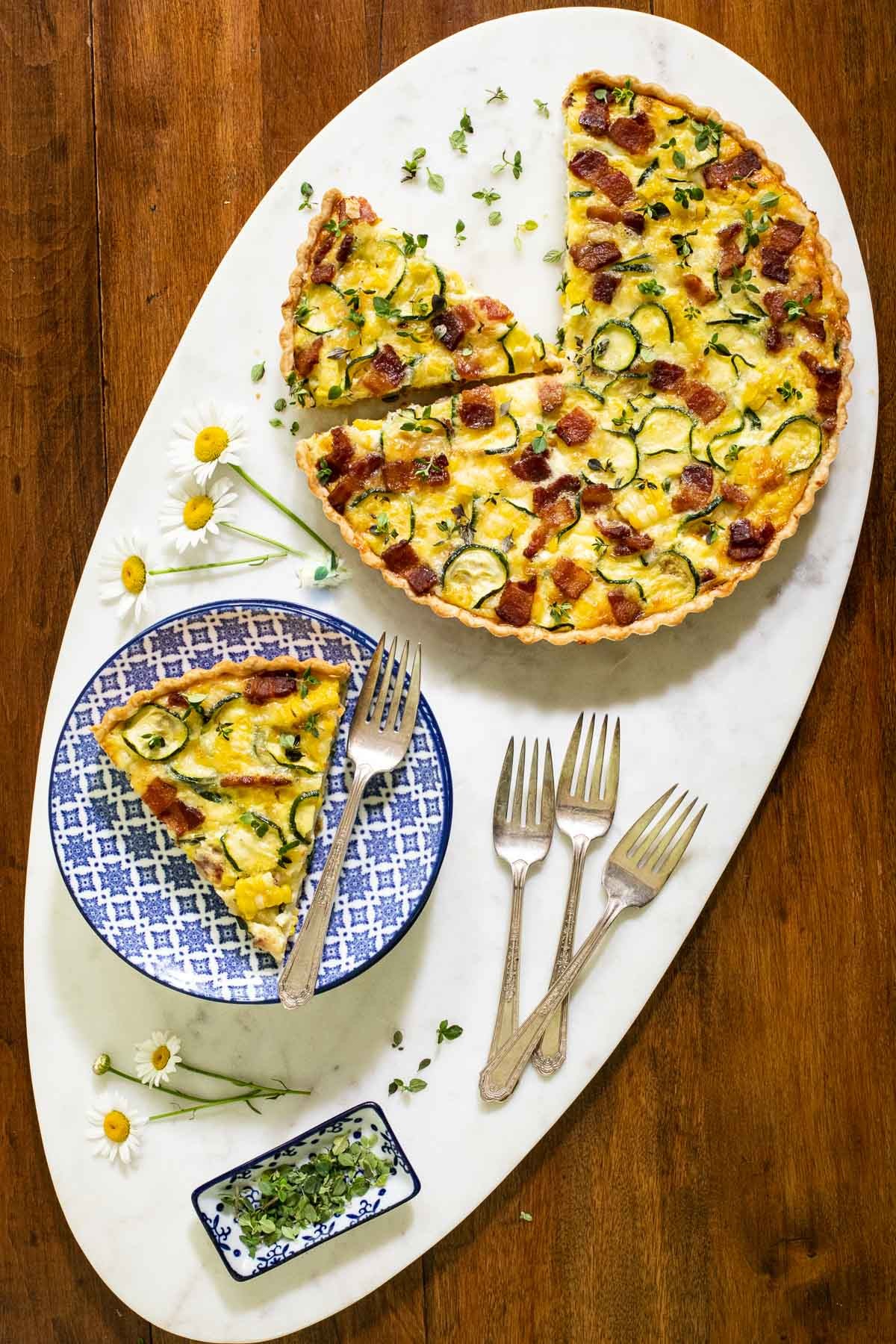overhead shot of a freshly baked summer vegetable quiche with a golden crust