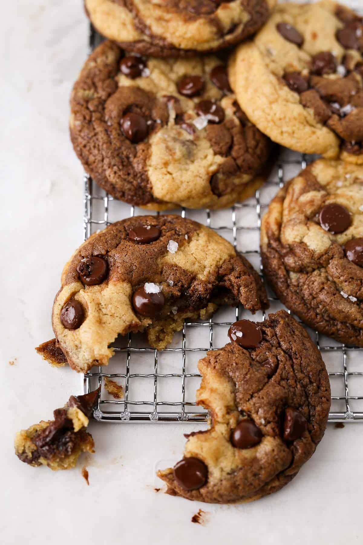 Homemade chewy chocolate marble cookies on a cooling rack, close-up, warm lighting