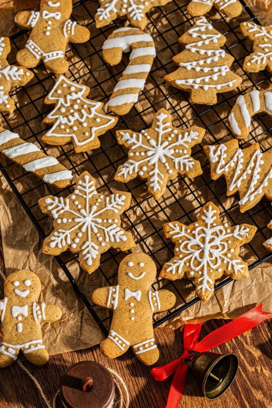 freshly baked gingerbread cookies decorated with intricate white icing on a festive holiday background