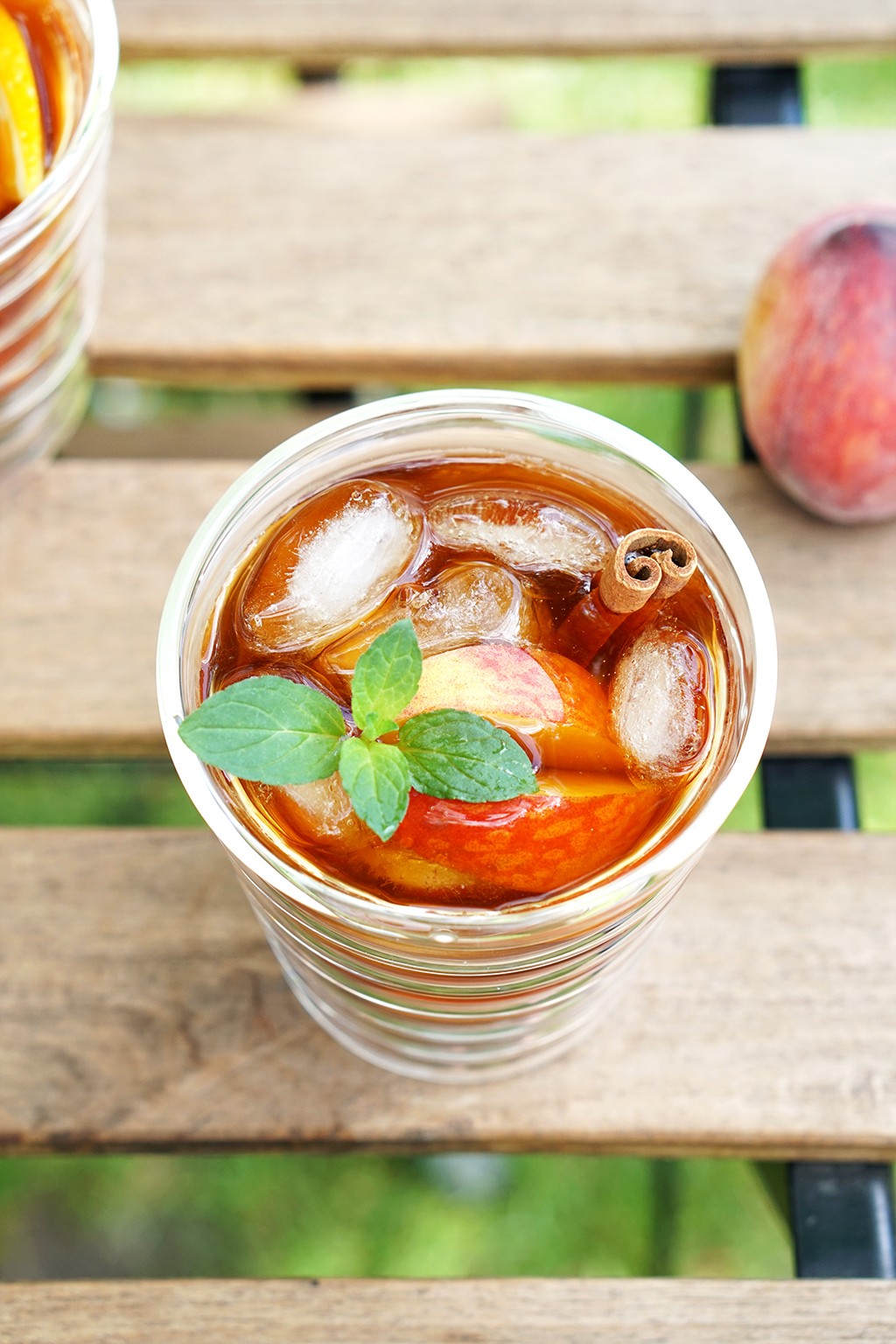 Apricot vanilla cold brew coffee in a glass with ice and apricot slices