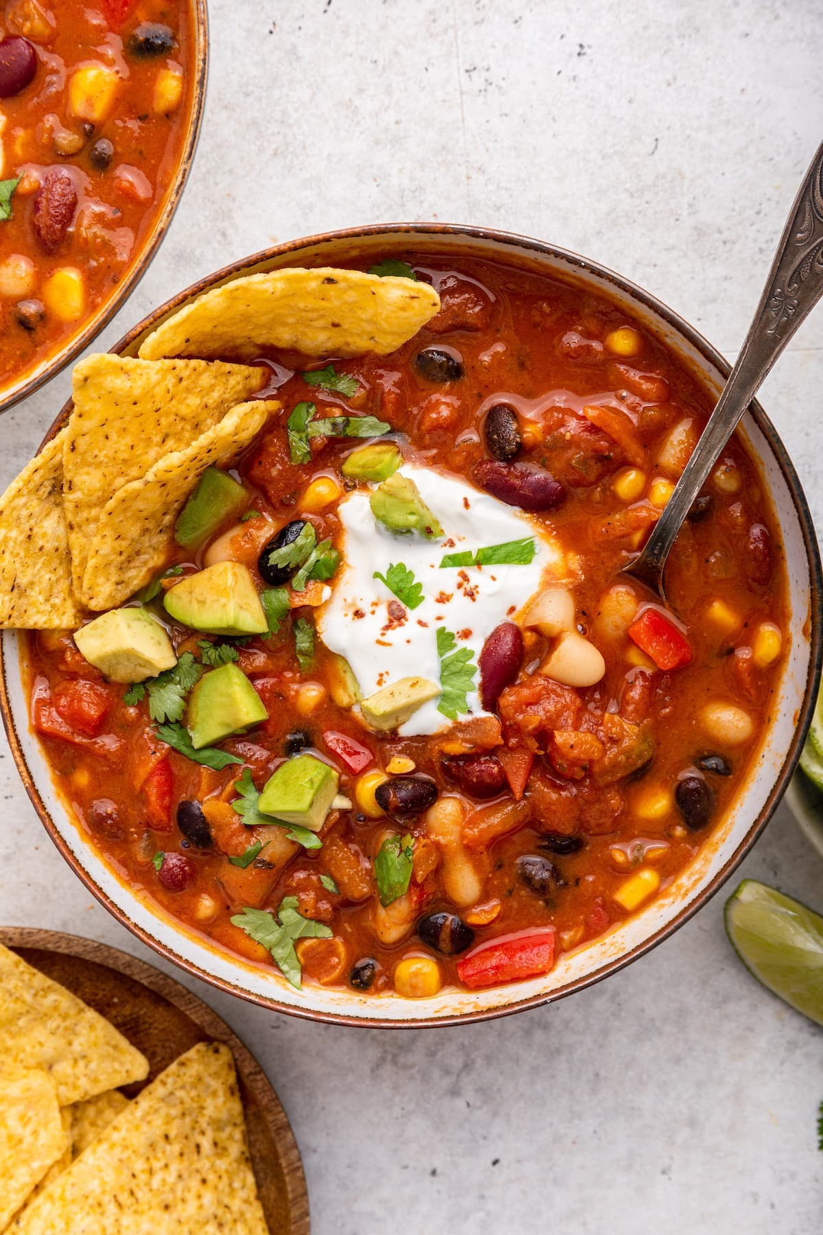 bowl of spicy vegan chili with peanut butter and toppings