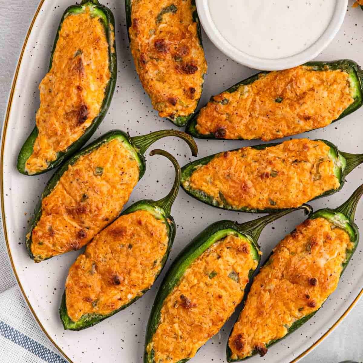 Platter of creamy stuffed jalapeños, baked and golden brown