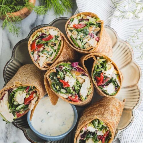 creamy chicken spinach wraps on a wooden board