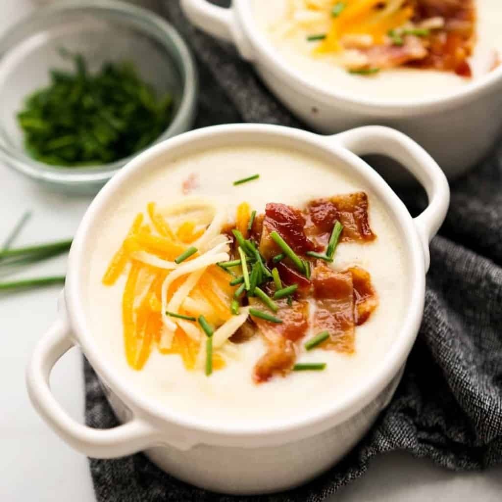 bowl of creamy potato soup with bacon and chives